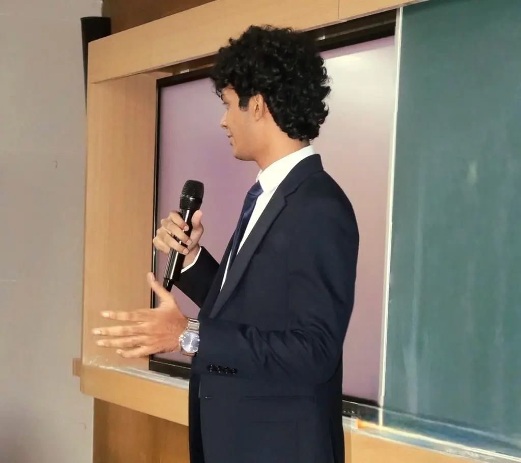 The founder, mic in hand, addressing the room
